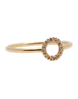 A dainty 14k yellow gold ring with a circle on top, set with brilliant cut white diamonds.