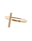 A dainty 14k yellow gold ring, with a vertical bar on top, set with nine tiny white diamonds.