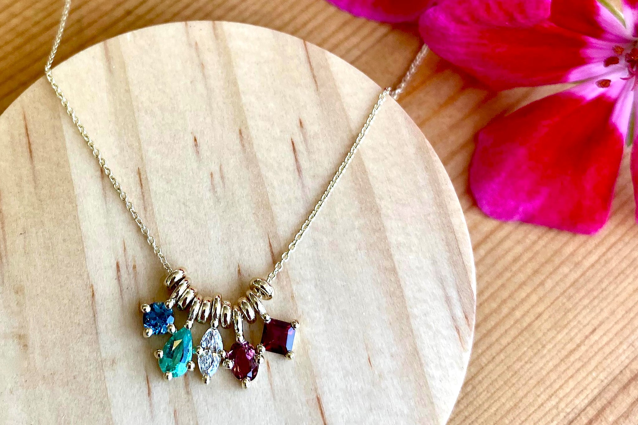 14K yellow gold chain with five precious stones pendants. From left to right: Blue Topaz, Green Emerald, White Diamond, Pink Tourmaline, Red Garnet