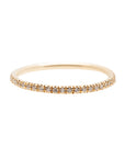 A dainty 14k yellow gold eternity ring, set with fifty 0.01 carat white diamonds all over.
