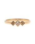 A delicate 14k yellow gold engagement ring, set with a center 0.25 carat princess cut white diamond, and three 0.01 carat brilliant cut white diamonds on each side.