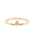 A dainty 14k yellow gold ring, set with one tiny, brilliant cut white diamond.